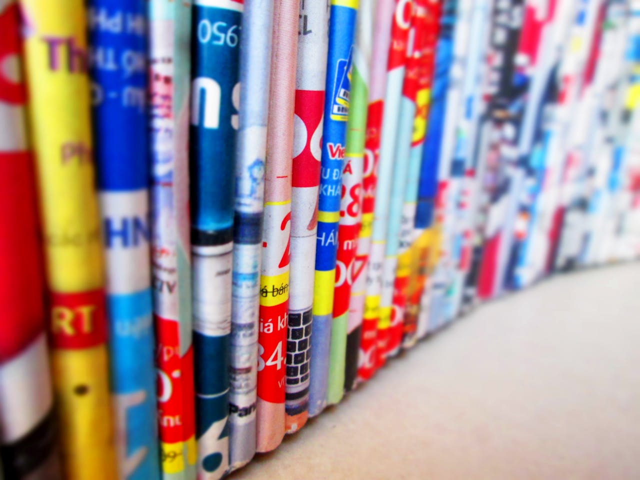 Vibrant, assorted rolled magazines create a colorful display.